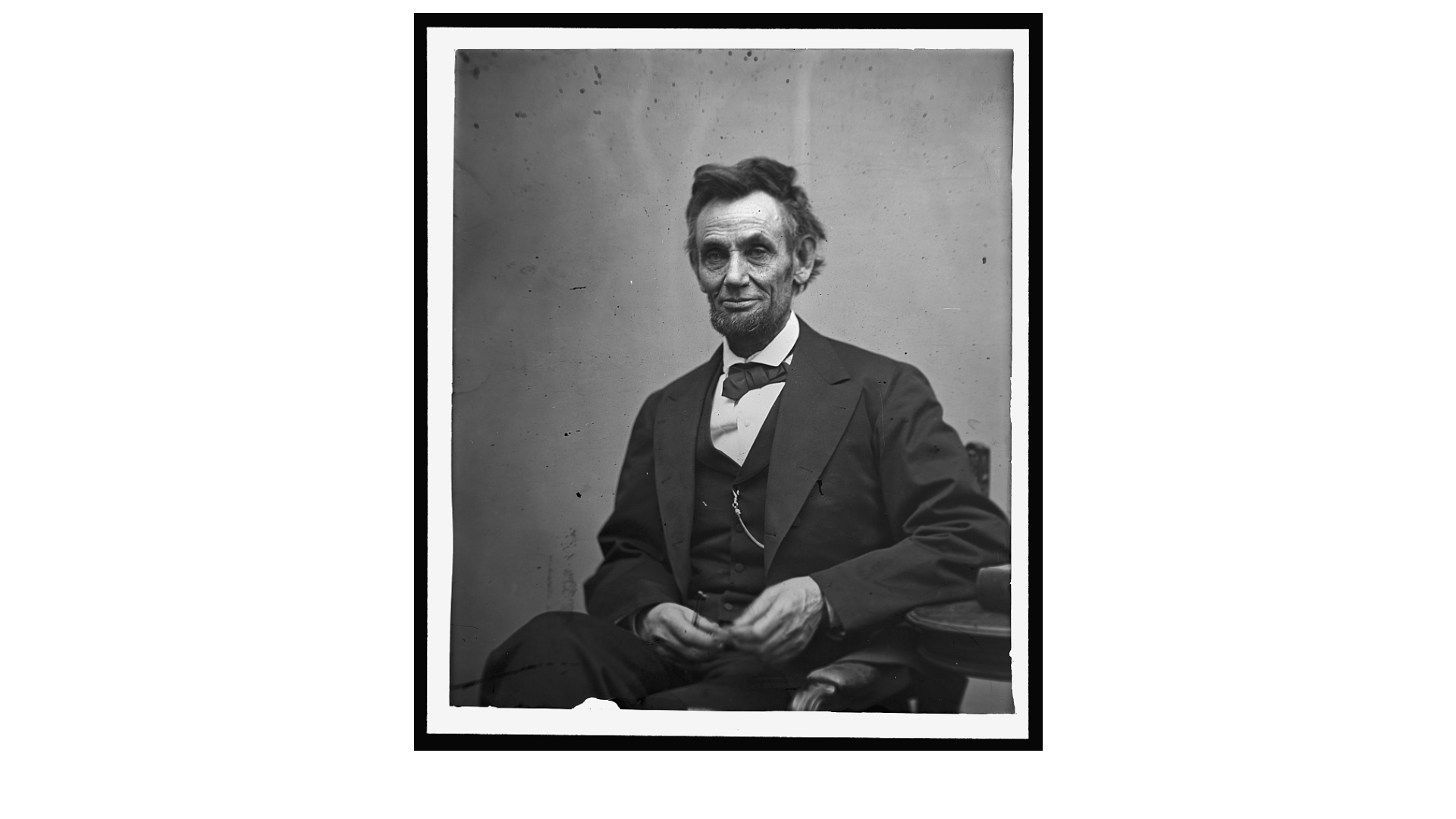 Black and white portrait of Abraham Lincoln seated.